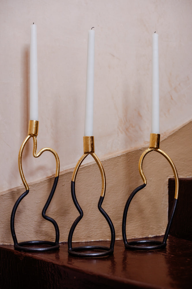 Three uniquely shapes candlesticks from Agnus Jones.  A Scottish artistic blacksmith.