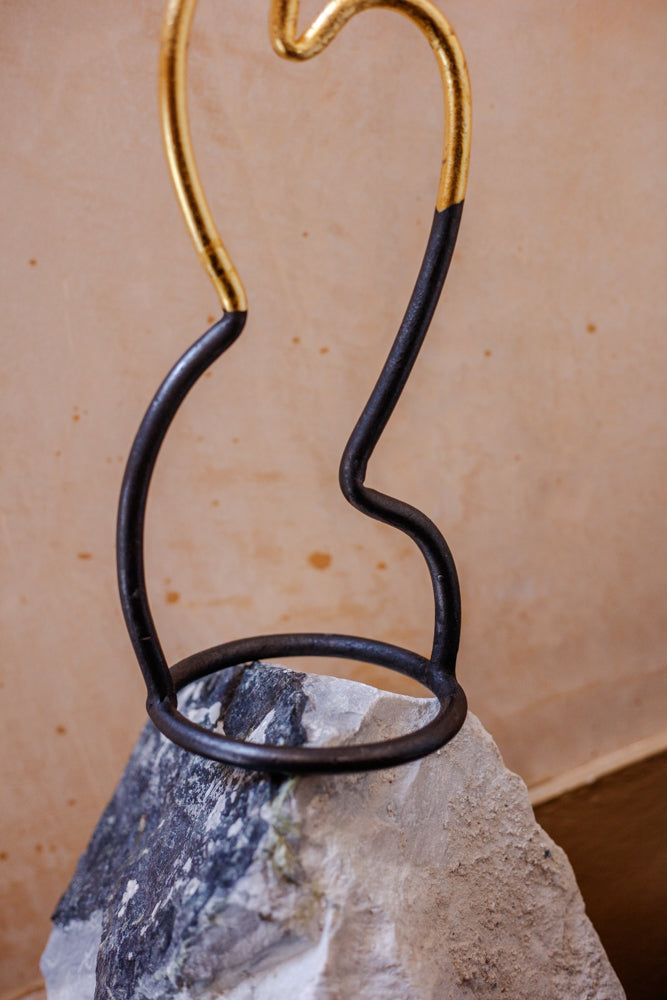 Close up of the base of Agnus Jones' gilded candlesticks. Balanced on a piece of Skye marble at Bard Scotland.