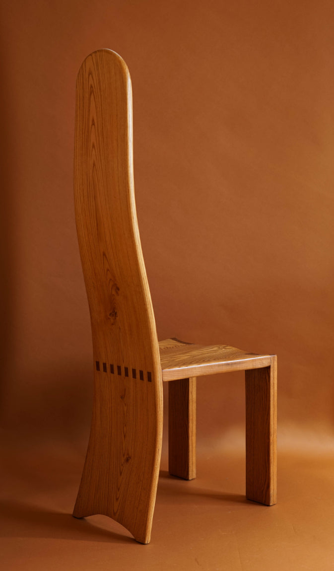 The curved sihlouette of these elm high backed chairs are sculptural and statement.