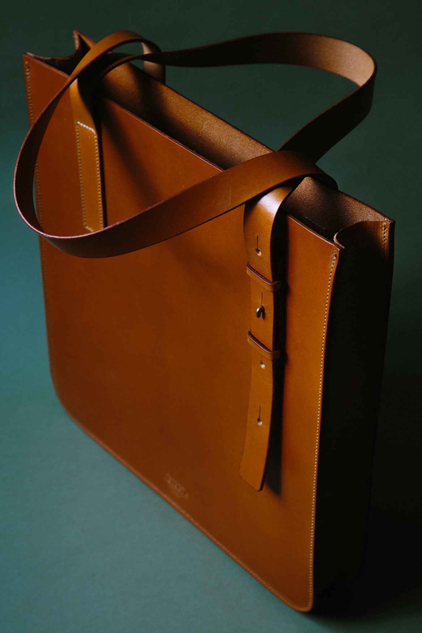 A third angle of the leather Lismore tote bag where the length of the handle can be seen and the inside of the unlined bag.