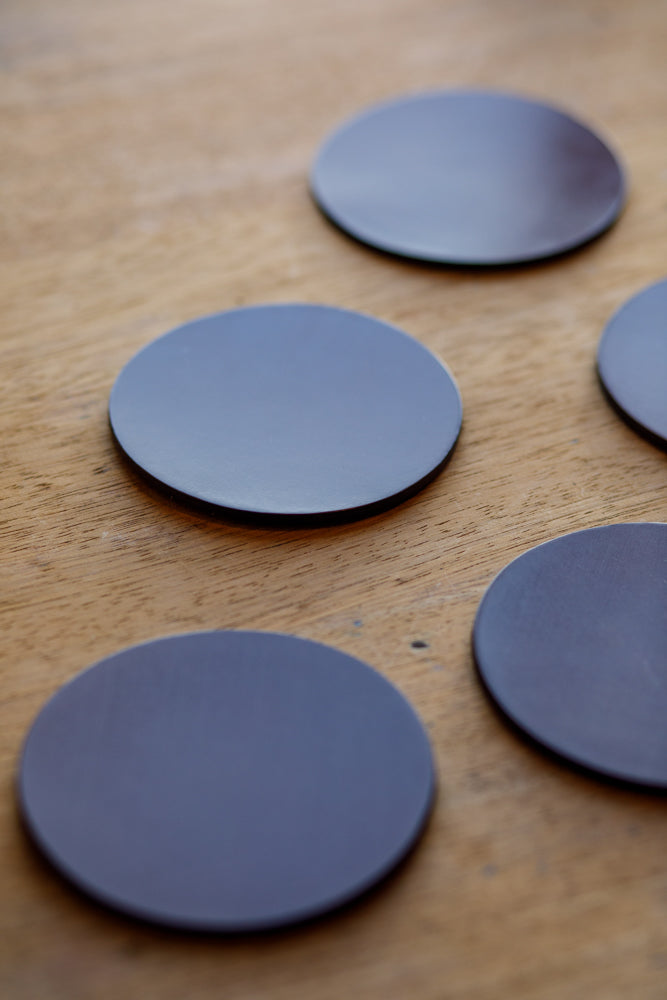 A grouping of five bridle leather coasters by McRostie Leather of Scotland. Now available at Bard in deep tan leather.