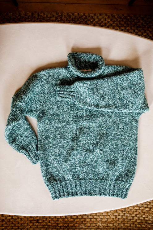 Lupetto neck jumper knitted by Shetland Woollen Co in Green Marl..