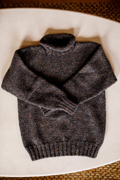 Lupetto neck jumper knitted by Shetland Woollen Co in the colour Charcoal Speck..