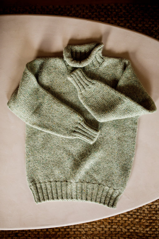 Lupetto neck jumper knitted by Shetland Woollen Co in Natural Green..