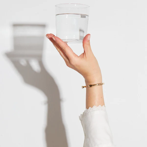 holding glass of water