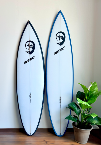 Two surfboards leaning against a wall