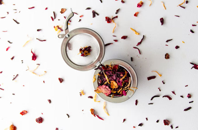 Tea Infuser with loose leaf tea scattered around