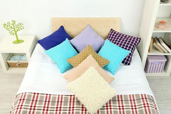 Bed with down pillow inserts in various covers.