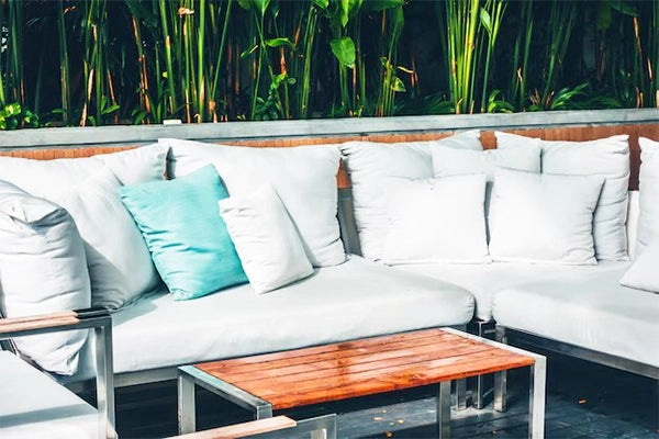 A set of outdoor pillows arranged on patio furniture, showcasing their weather-resistant qualities.