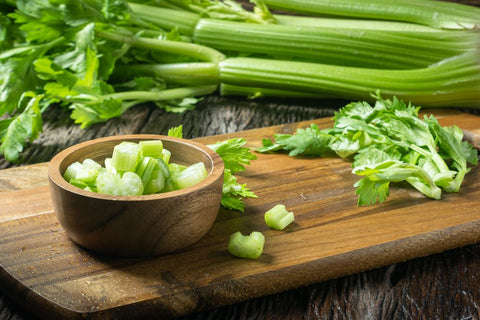 chopped up celery in a wooden bowl