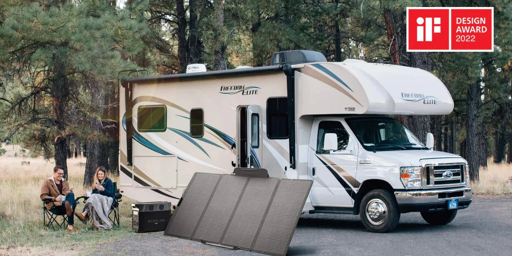 A couple sitting next to their beautiful Ford motorhome outside in a pine forest enjoying the outdoors with constant flow of electricity thanks to EcoFlow power station and EcoFlow solar panels