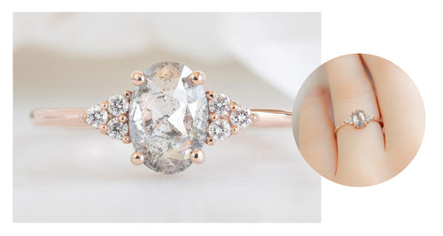 rose gold engagement ring featuring an oval-cut salt and pepper diamond with a seven stone setting