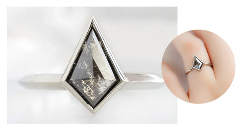 white gold engagement ring featuring a black kite shaped diamond in a bezel setting