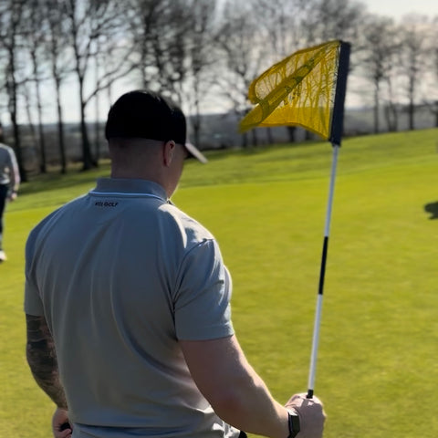 Golfer holding flag