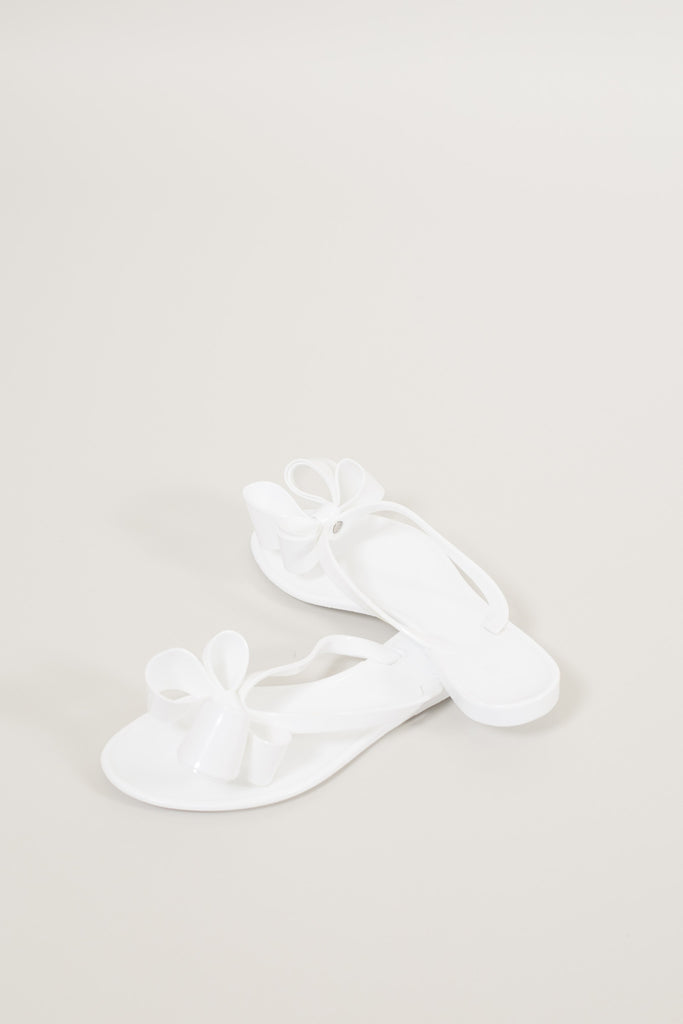 white bow flip flops