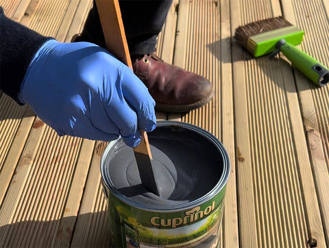 Cuprinol paint being stirred