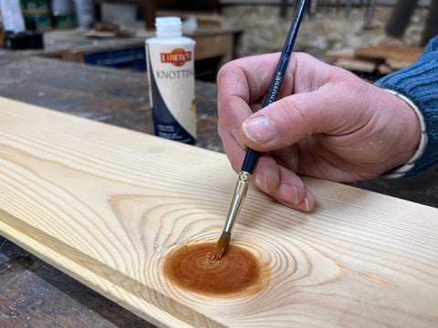 knotting being applied to pine wood