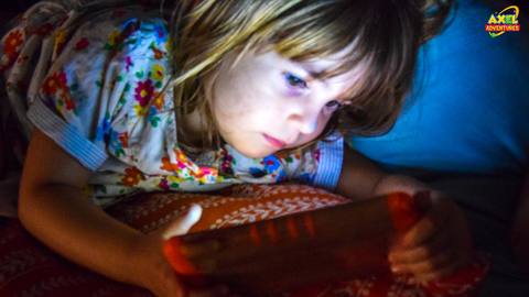 Kid consuming screen time at night and in an dark environment
