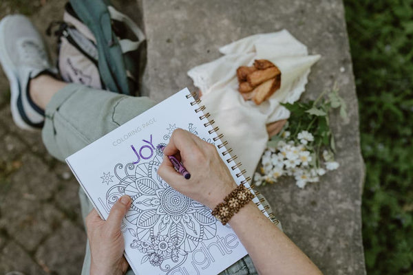 coloring in a mindfulness journal outside