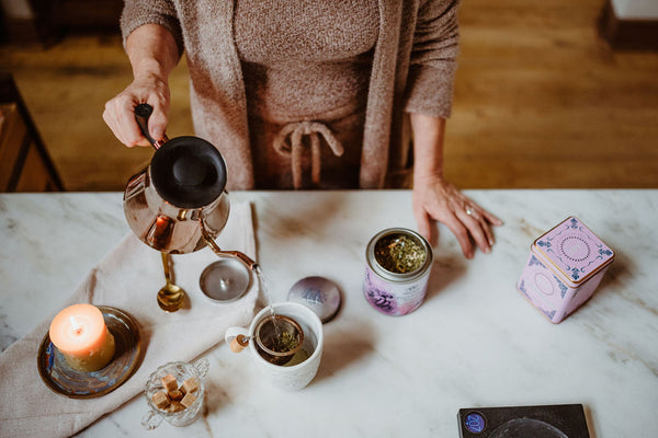 Woman preparing tea practicing gratitude mindset