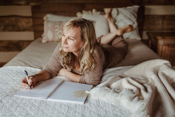 Woman using JMB Living Journal to Vision Board for dreams