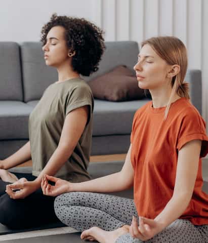 two ladies doing meditation