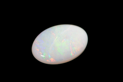 Isolated white oval opal on black