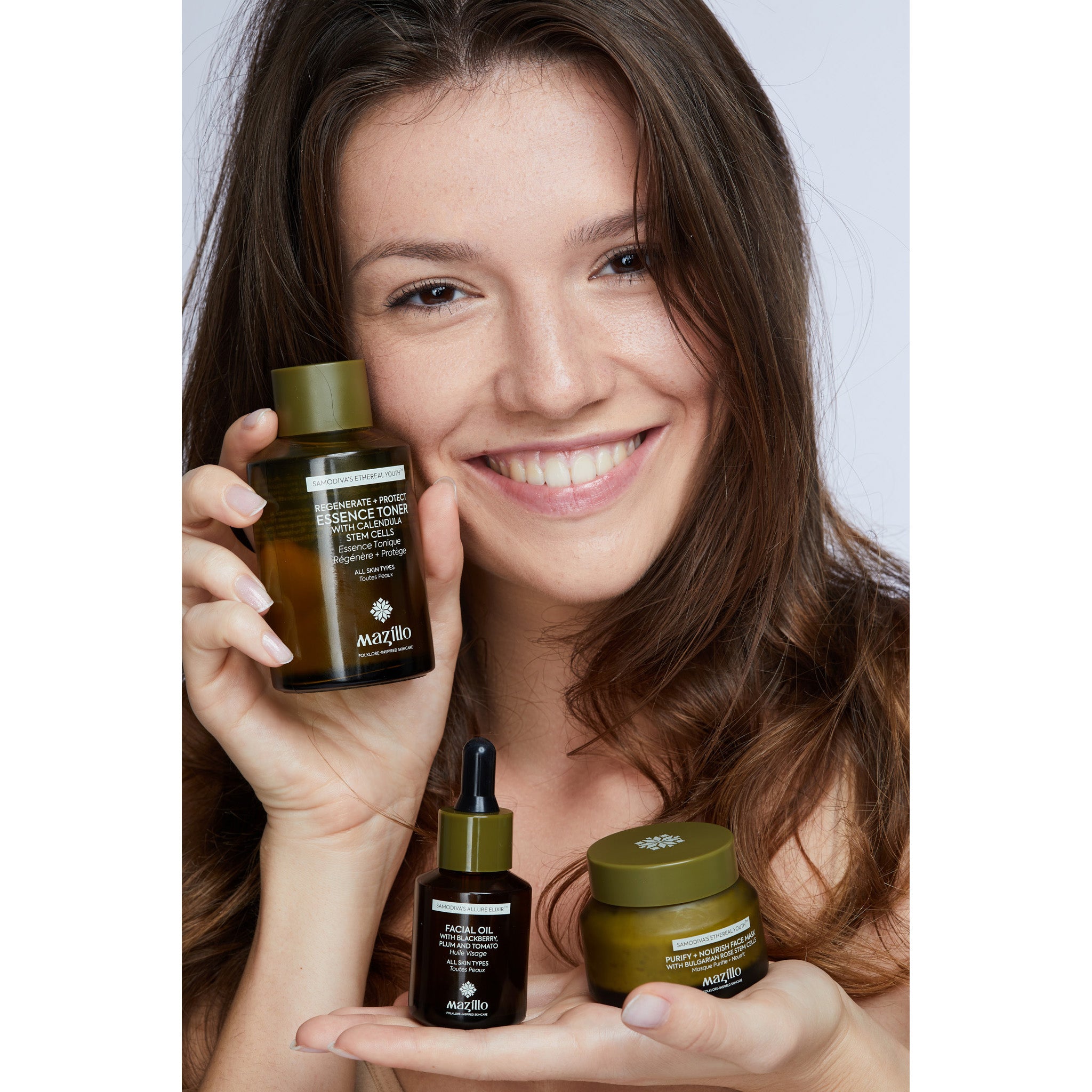 Pop up image of girl holding 3 Mazillo products
