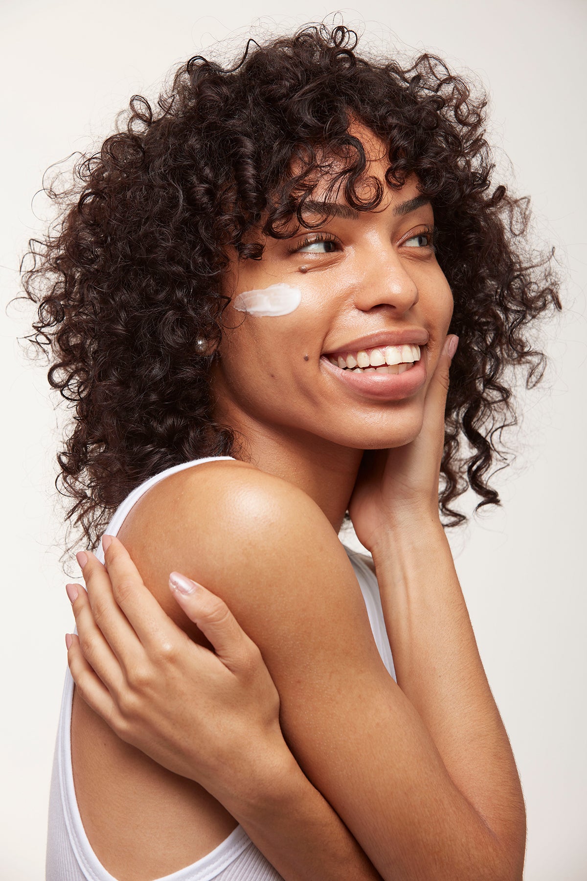 woman with cream applied to her cheek