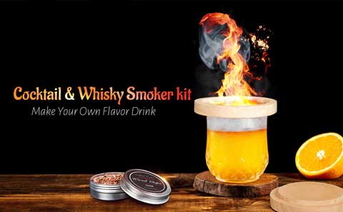 Cocktail glass with the Guaiacol Infuser™ and a fire creating billowing smoke from wood chips