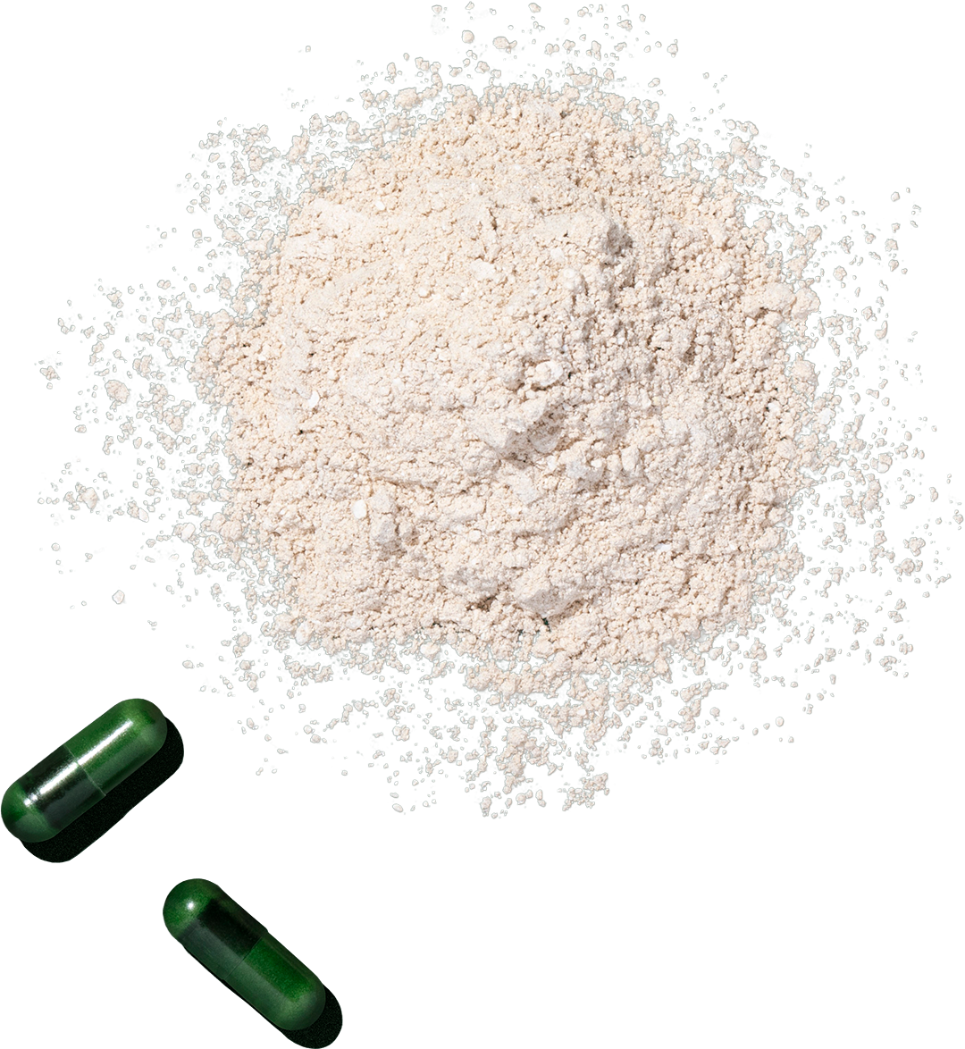 A mound of white powder with two green capsules nearby.