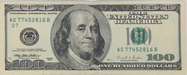 the counterfeit dollar on the left hand