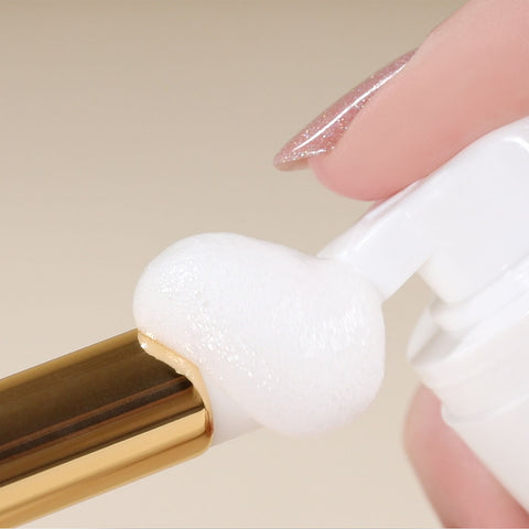 foam cleanser being applied to a lash cleansing brush