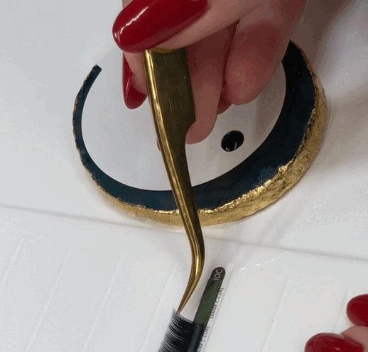 dipping an eyelash extension in glue
