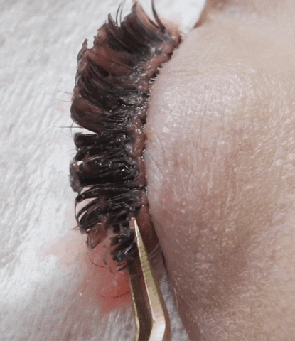 a gif showing eyelash extensions being removed