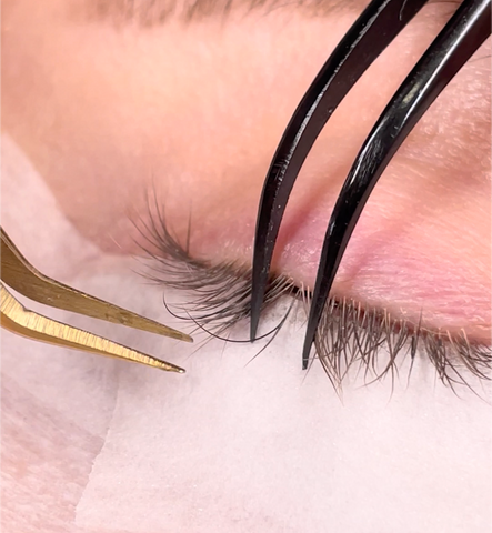 a classic eyelash extension being applied during a patch test