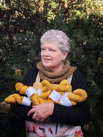Anne with her hand dyed yarns in her backyard in Latrobe, Tasmania.