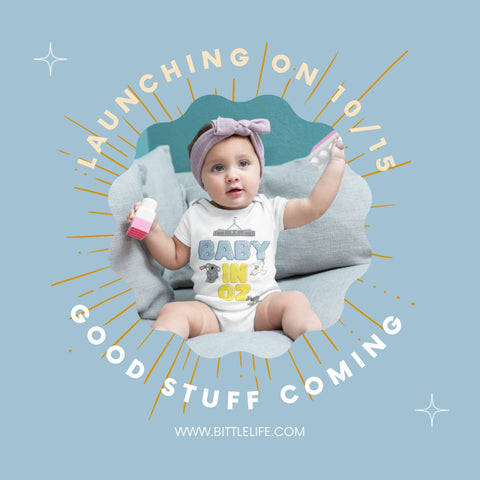 Baby in US in OZ onesie designed by Bittle Life announcing Official Product Launch