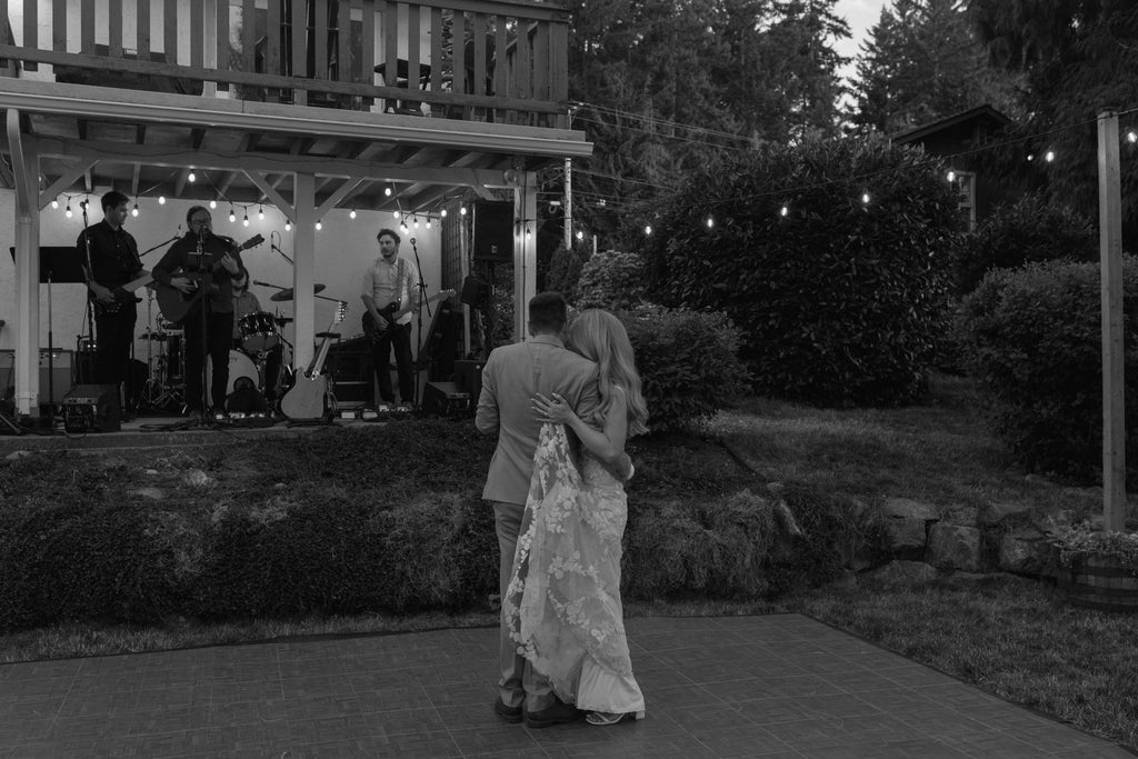 Bride and groom having their first dance with a band playing in the background.