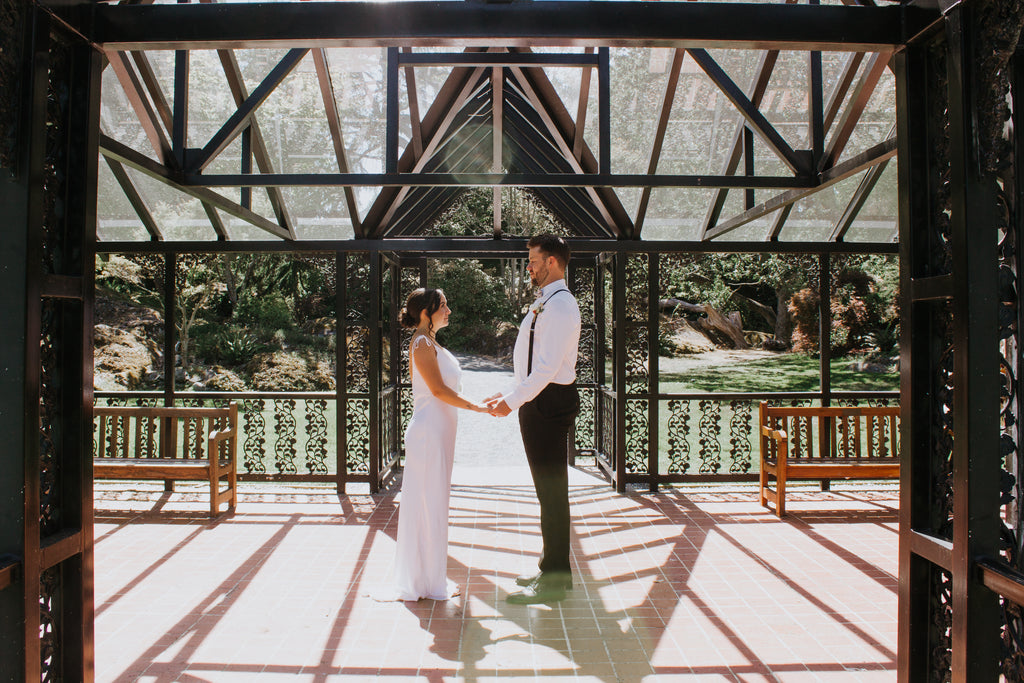 Bride and groom under a glass urban roof