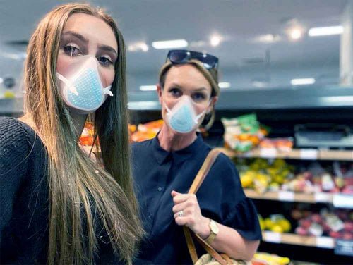 2 ladies wearing breathe happy mask in a shop