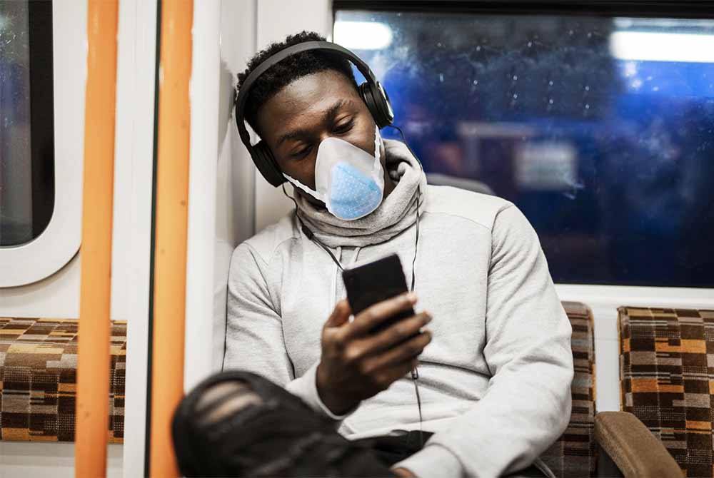 man wearing breathe happy commuter mask on underground train