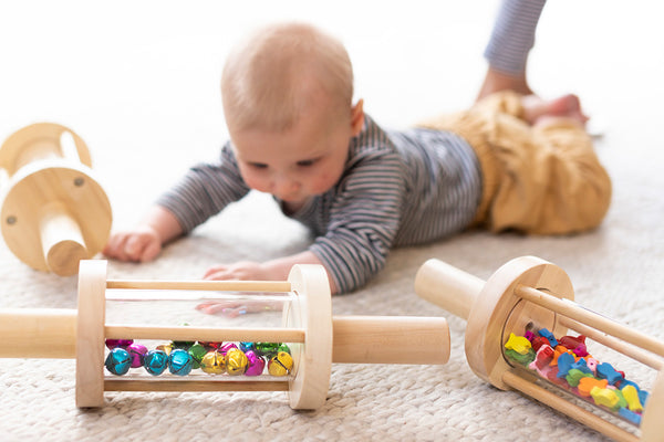 baby playing with wooden montessori toys