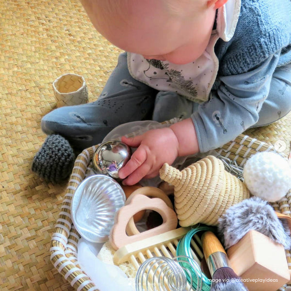 baby playing heuristic basket