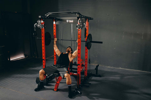 a man doing bench press on power rack called plm03