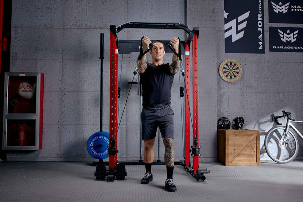 man doing cable front raise on major fitness power rack plm03