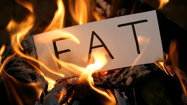 paper with the word FAT burning in a fire
