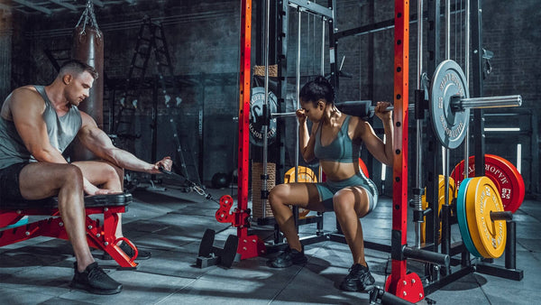 a couple working out at smith machine