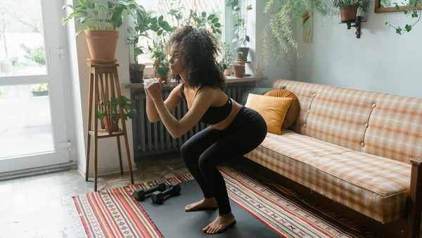 a female doing body weight squat at home