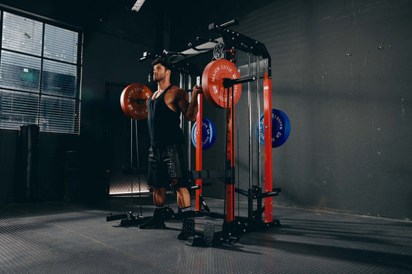 Man performing strength training with a Smith machine and red weight plates.